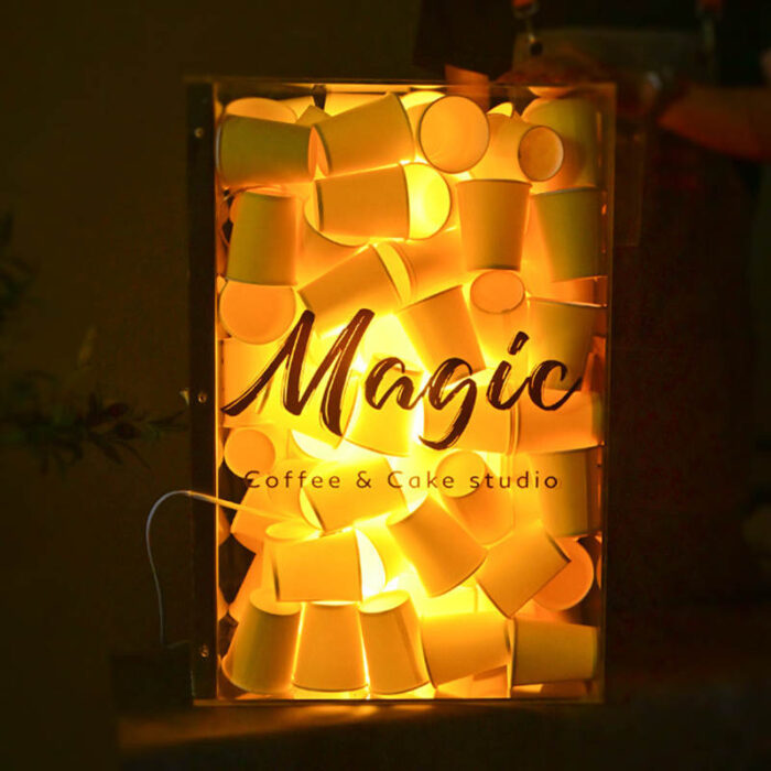 acrylic light box filled with paper cups yellow light