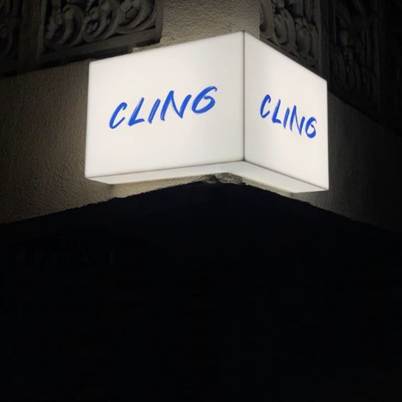 corner acrylic lightobx sign with white light and blue printed text