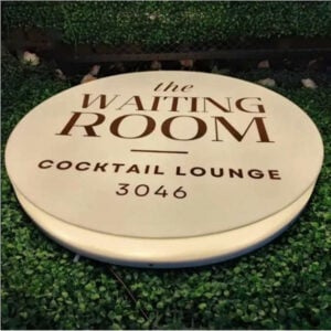 Round acrylic light box sign for cocktail lounge with warm light