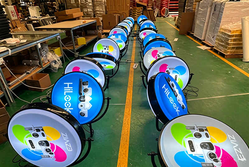 Bulk produced rotating lightbox wall signs under power-on testing 